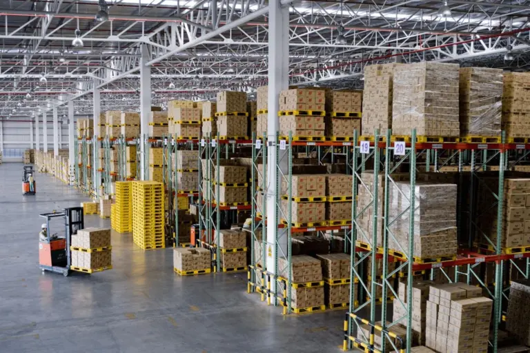 warehouse-with-stacked-boxes-and-pallet-truck-drivers