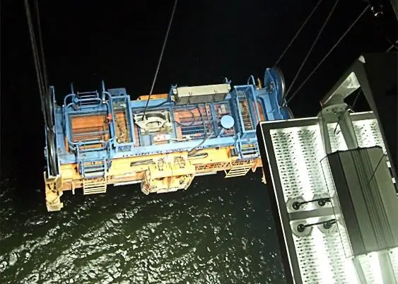 MCH Trolley Over Water: This picture shows four 300W LED floodlights (Phoenix Products - ModCom Hi’s) mounted on the trolley of an STS crane illuminating the spreader over the water