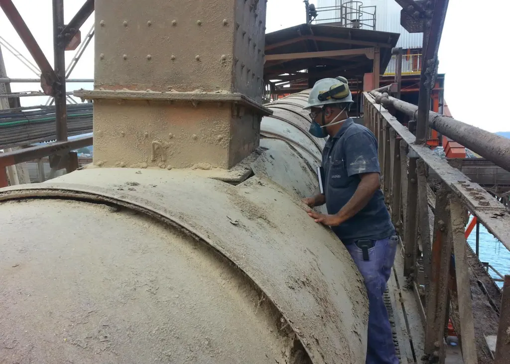 Worker inspecting chute