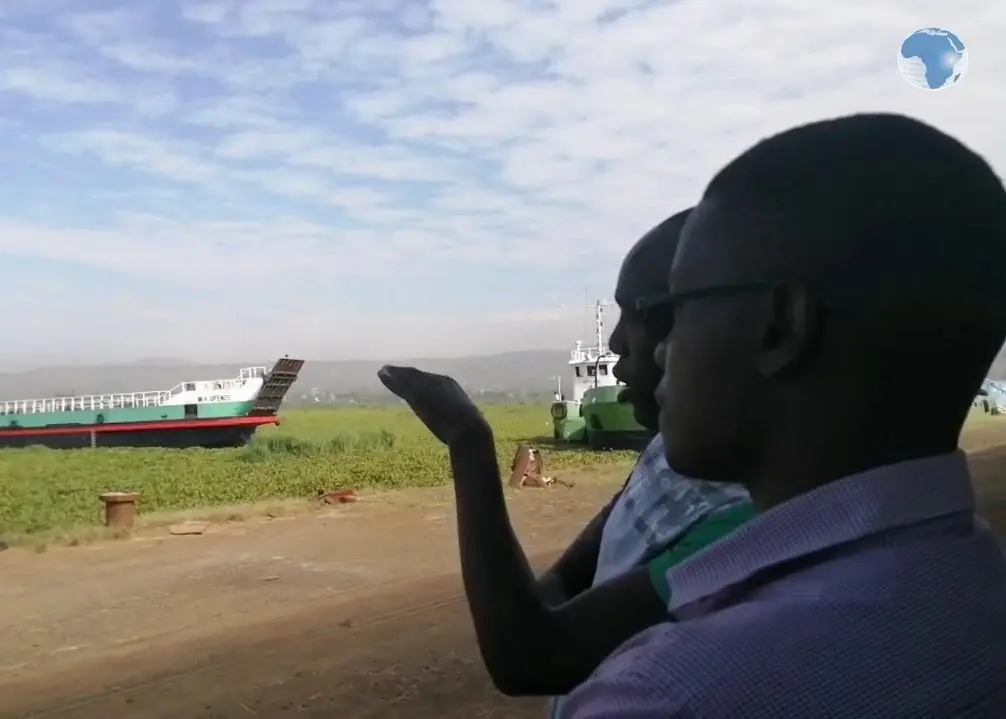 A cargo ship attempting to dock at the water hyacinth-filled Kisumu Port.