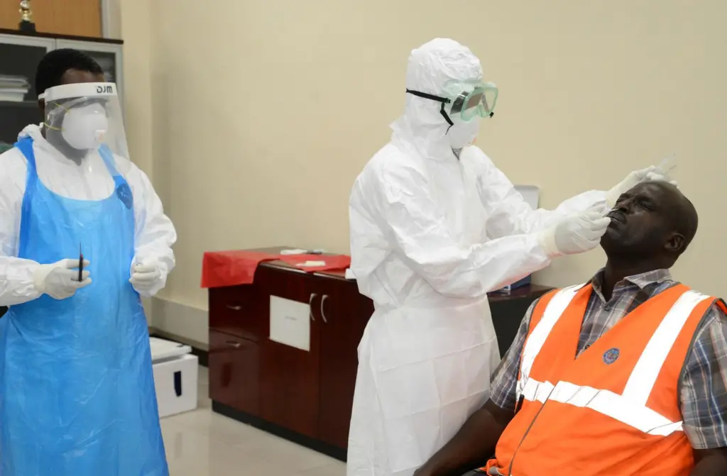 Health personnel extracting nose samples from a KPA employee during a Covid-19 testing exercise at the port of Mombasa