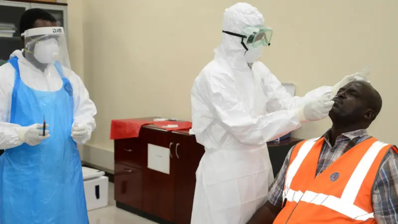 Health personnel extracting nose samples from a KPA employee during a Covid-19 testing exercise at the port of Mombasa