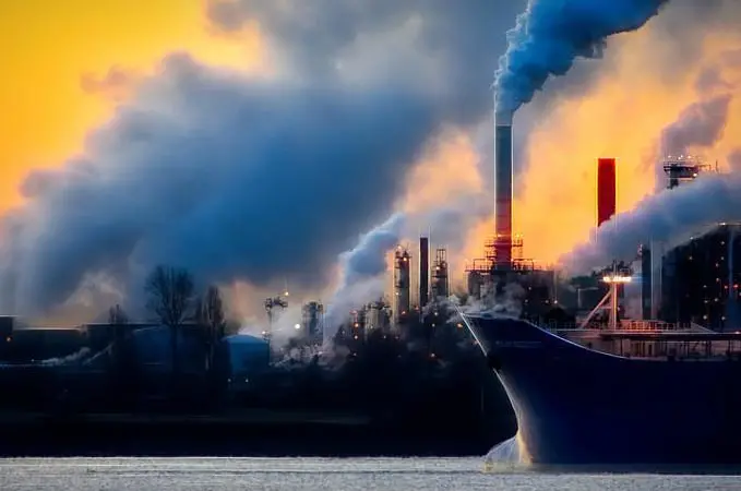 Ship at port with billowing smoke