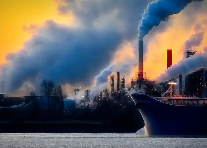 Ship at port with billowing smoke