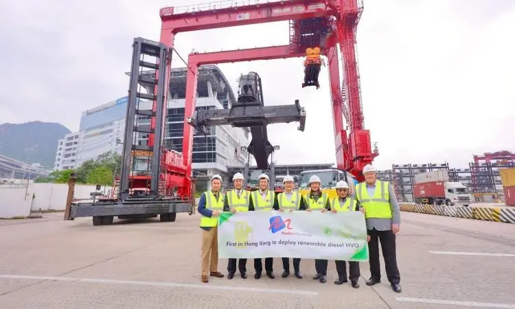 Representatives from Modern Terminals in front of a crane celebrating an HVO trial