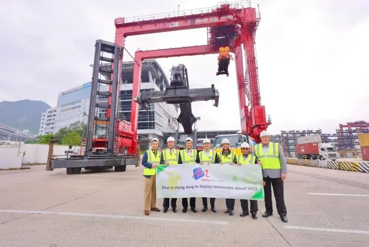 Representatives from Modern Terminals in front of a crane celebrating an HVO trial