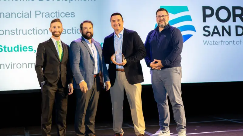 The image shows Michael LaFleur, Vice President of Maritime and Ernesto Medina, Chief Engineer at the Port of San Diego receiving their award from Cary Davis, President and CEO of the AAPA