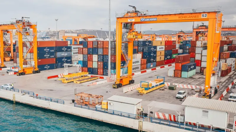 The image shows electric RTGs on the quayside at Slovenia's Port of Koper