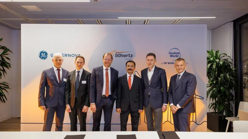 The image shows six representatives from the companies at the project signing