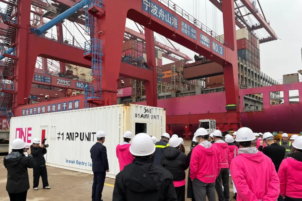 The image shows ONE’s AMP container beng lifted into place at NZPG’s terminal