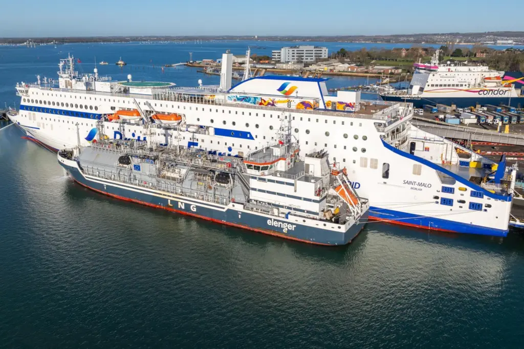 The image shows The Brittany Ferries’ electric-hybrid vessel, Saint-Malo, receiving LNG bunkering from Optimus