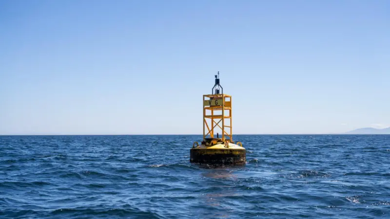 The image shows MarineLabs monitoring technology attached to a harbour buoy