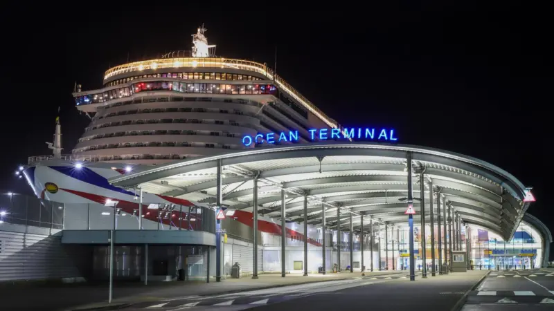 The image shows ABP's Southampton’s iconic Ocean Terminal lit up at night