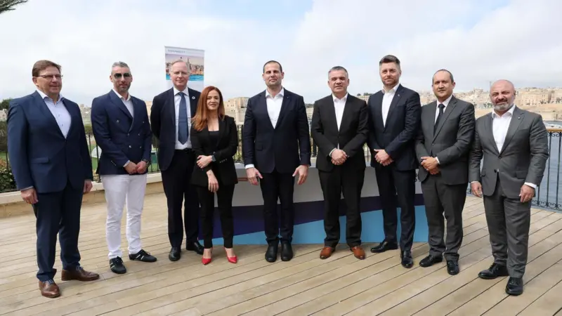 The image shows a crowd of signatories to the shore power agreement including Robert Abela, PM of Malta and representatives from Valletta Cruise Port and Global Ports Holdings, Transport Malta and Carnival Corps