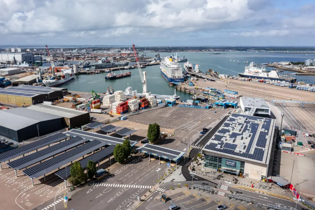 The image shows an overhead shot of ferries berthing at Portsmouth International Port