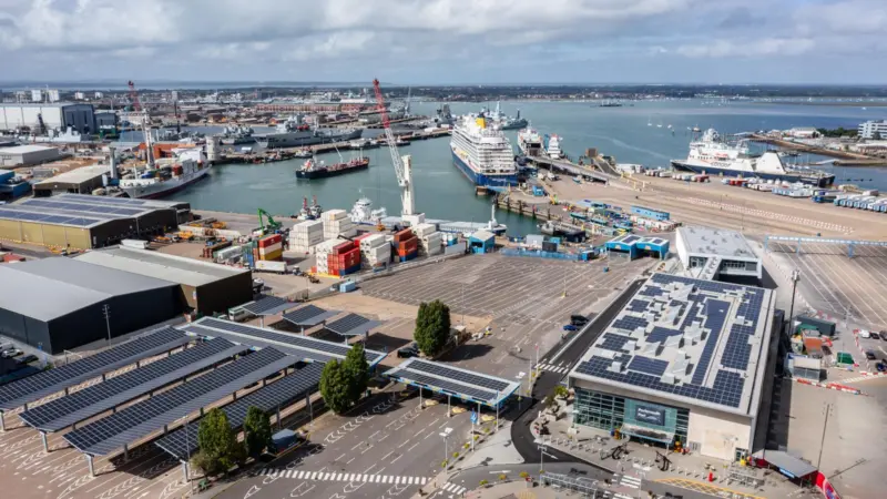 The image shows an overhead shot of ferries berthing at Portsmouth International Port