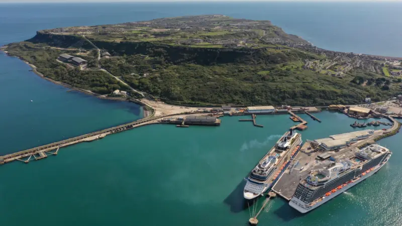 The photo shows an overhead shot of Portland Port in Dorset, UK