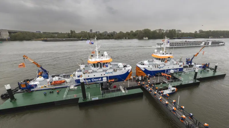 The image shows the christening service of Van Oord's two new hybrid water injection dredgers (WIDs), Rijn and Rhône