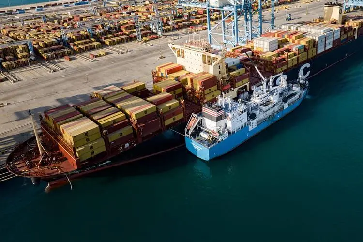 The photo shows the container vessel MSC Thais refuelling from the Green Zeebrugge, operated by marine fuels provider Monjasa