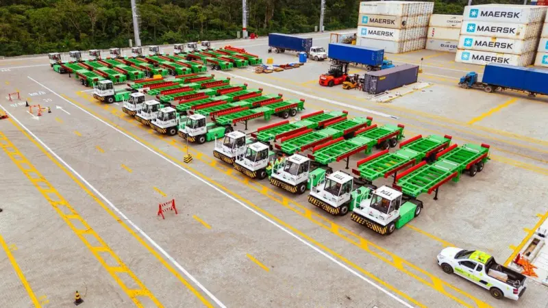 The image shows an overhead shot of the Sany electric terminal tractors in the terminal yard