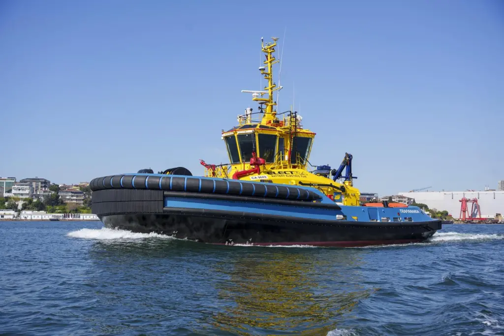 The picture shows a SAAM electric tug on the water