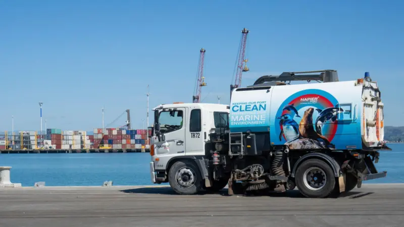 The image shows the port's new Sweeper Truck 'Sweeping Beauty' on the quayside