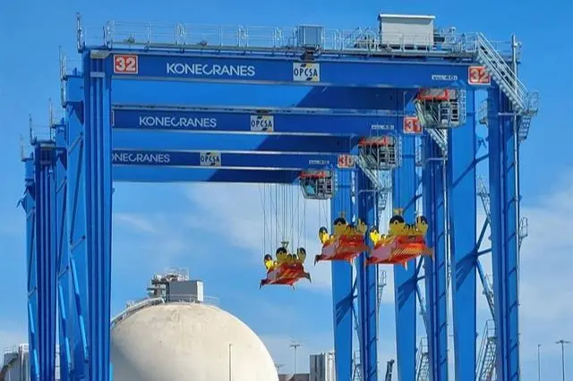 The image shows the Konecranes hybrid RTGs already in operation at OPCSA
