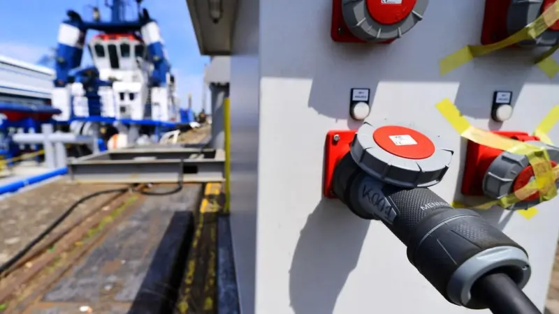 The image shows a ship on shore power