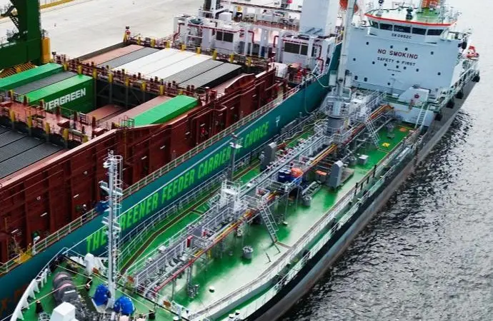 The image shows the first simultaneous methanol bunkering and cargo operation at Tuas Port