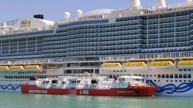 The Haugesund Knutsen LNG barge alongside a cruise ship at the Port of Barcelona