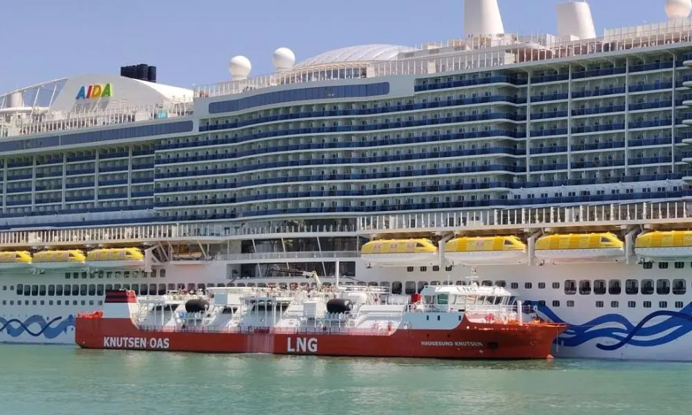 The Haugesund Knutsen LNG barge alongside a cruise ship at the Port of Barcelona