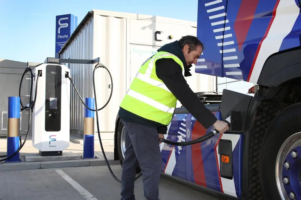 An image of a person charging an electrical HGV at the Tilbury eHGV charing hub