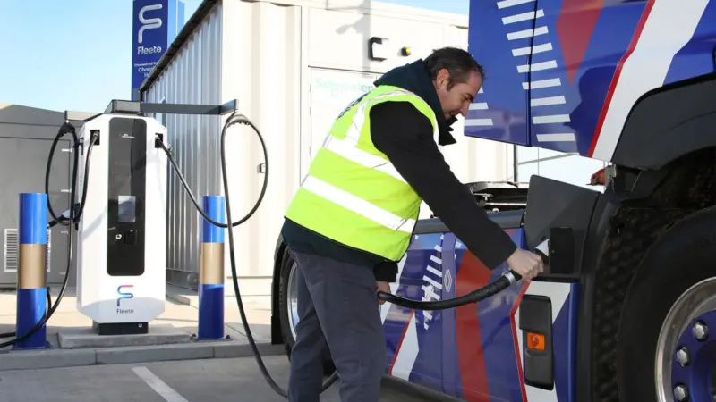 An image of a person charging an electrical HGV at the Tilbury eHGV charing hub