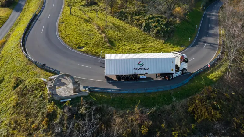A picture of a DP World branded freight truck on the road