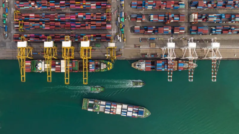 Cargo ship and truck at seaport waiting for container dock by crane shipment