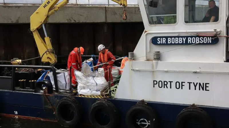 A  view of the pellets being collected and loaded onboard port vessels