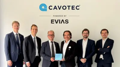 Members of Cavotec and EVIAS at a signing ceremony to mark a partnership deploying electric charging at ports