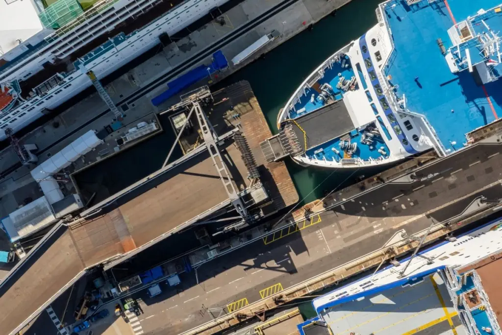 Boat coming into dock aerial image