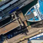 Boat coming into dock aerial image