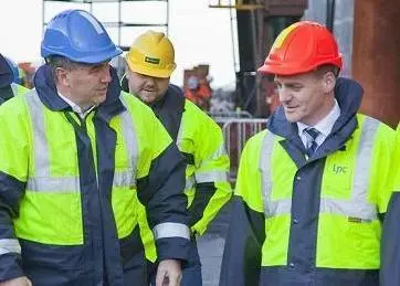 Lyttelton CEO Peter Davie shows New Zealand acting Prime Minister Bill English (right) how repairs to earthquke-hit port infrastructure are progressing