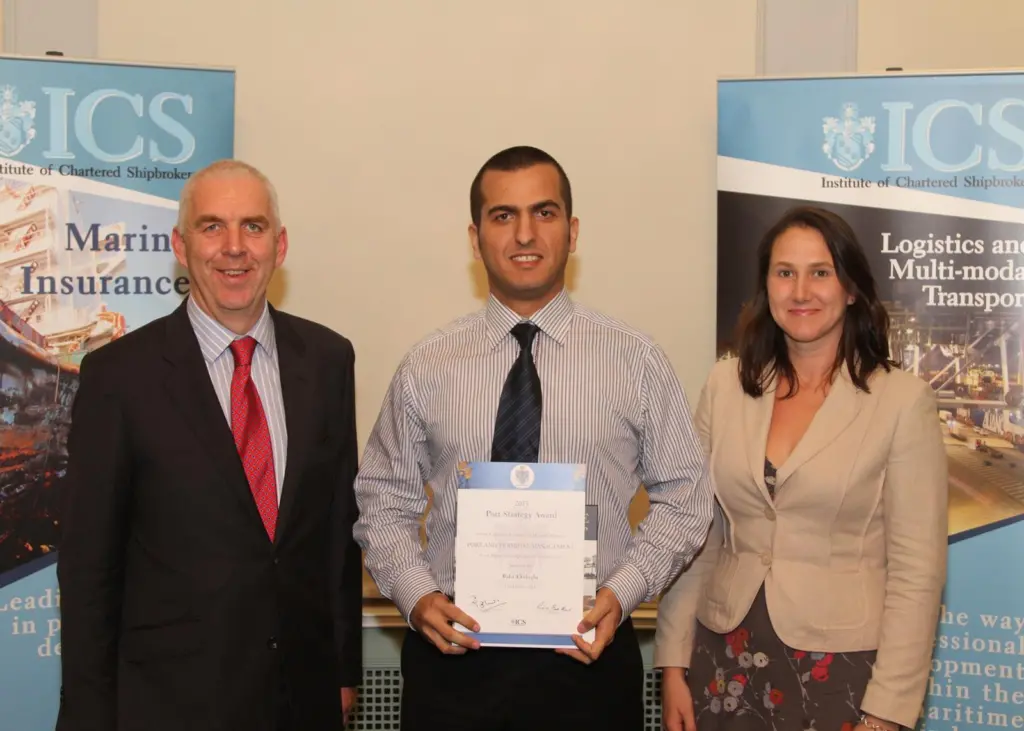 Carly Fields (R) presents Baha Eksioglu (middle) with the Port Strategy Award