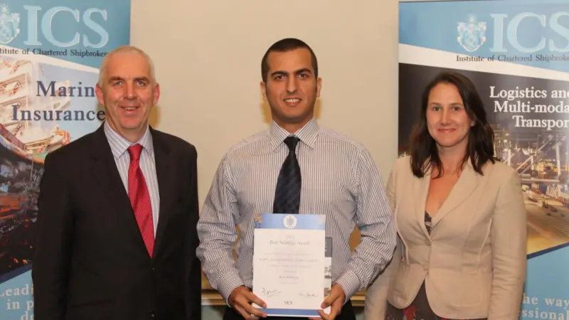 Carly Fields (R) presents Baha Eksioglu (middle) with the Port Strategy Award