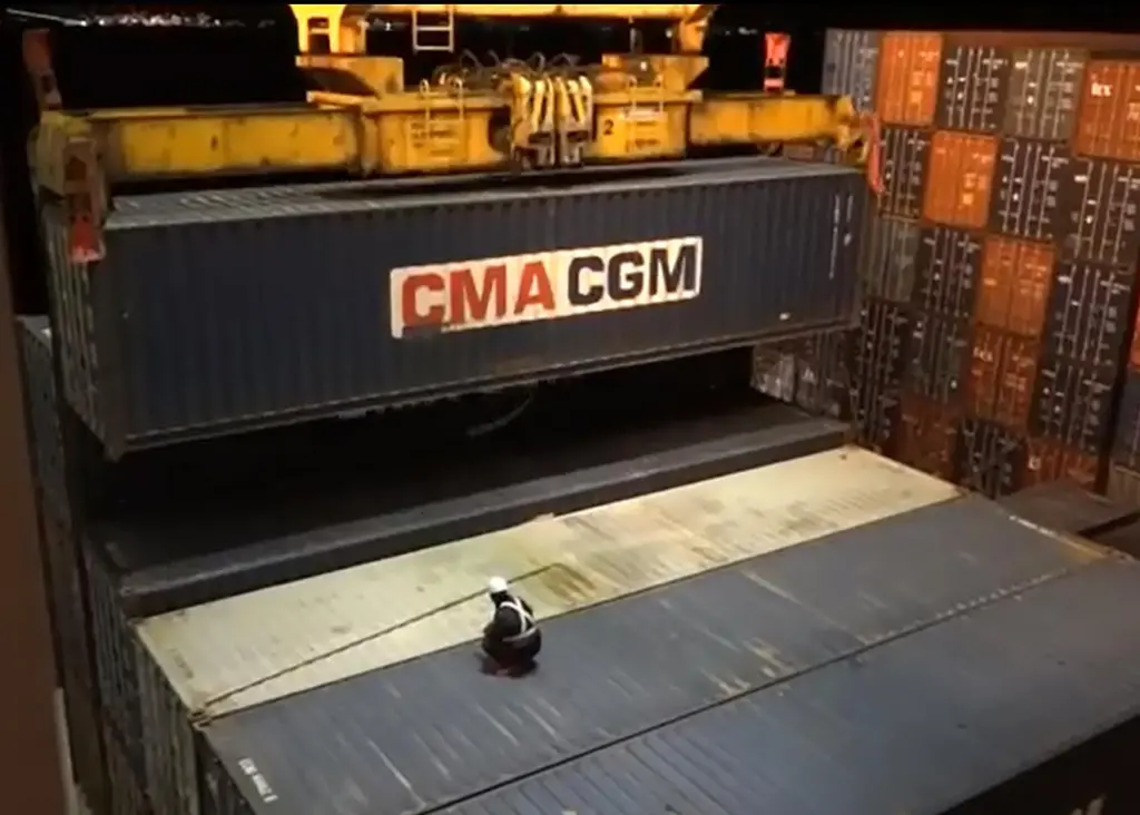 Dockworker on dramatically dangerous twistlock operation: courtesy of YouTube