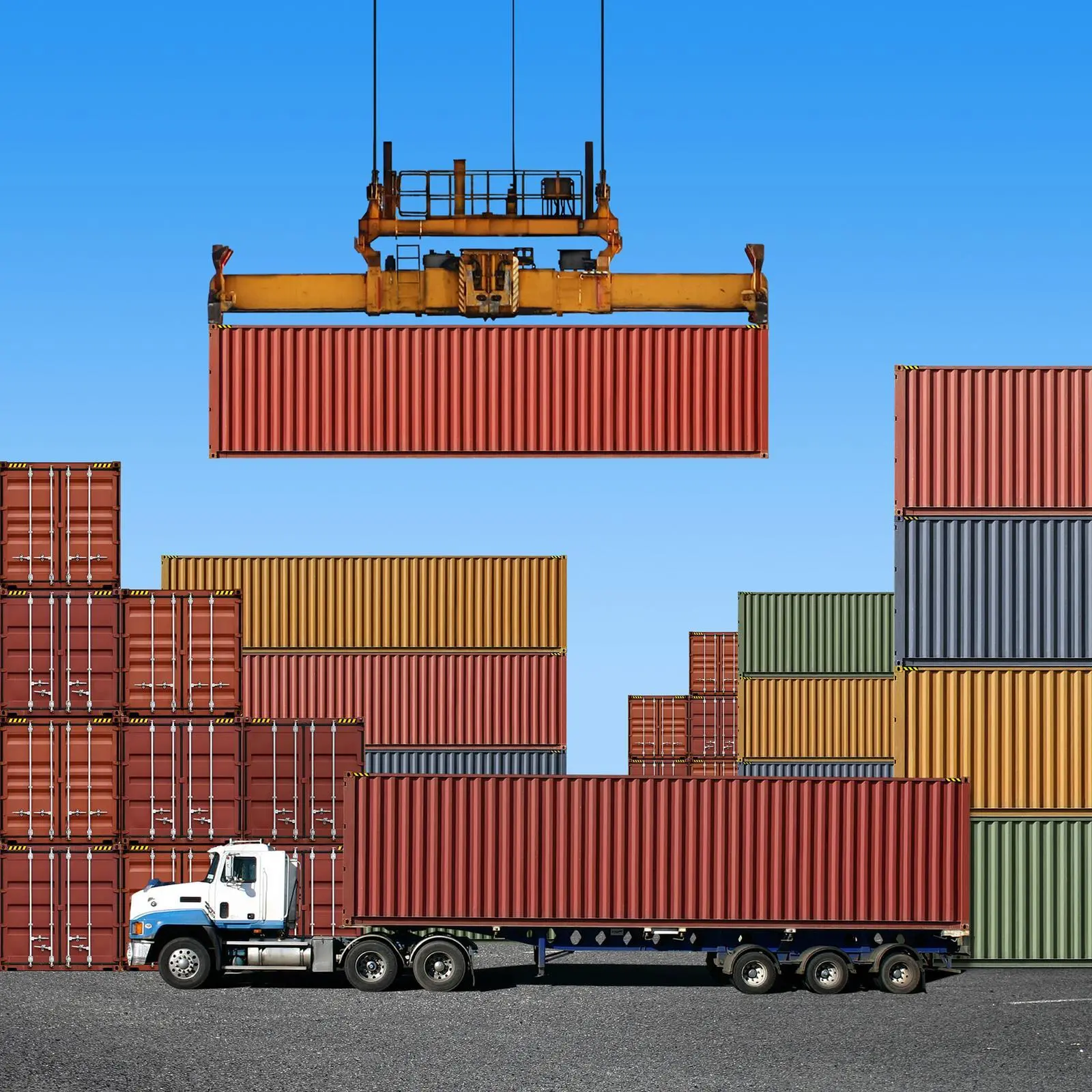 A cargo crane loading a container, with a truck in the foreground.