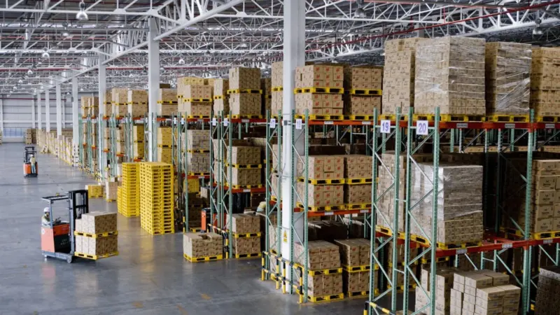 warehouse-with-stacked-boxes-and-pallet-truck-drivers