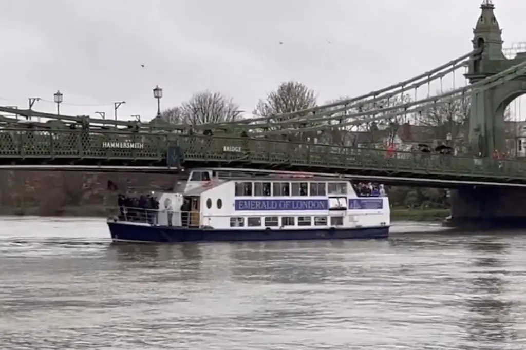 Emerald of London pleasure boat stuck under Hammersmith Bridge on the River Thames