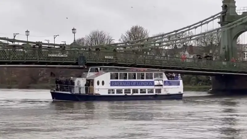 Emerald of London pleasure boat stuck under Hammersmith Bridge on the River Thames
