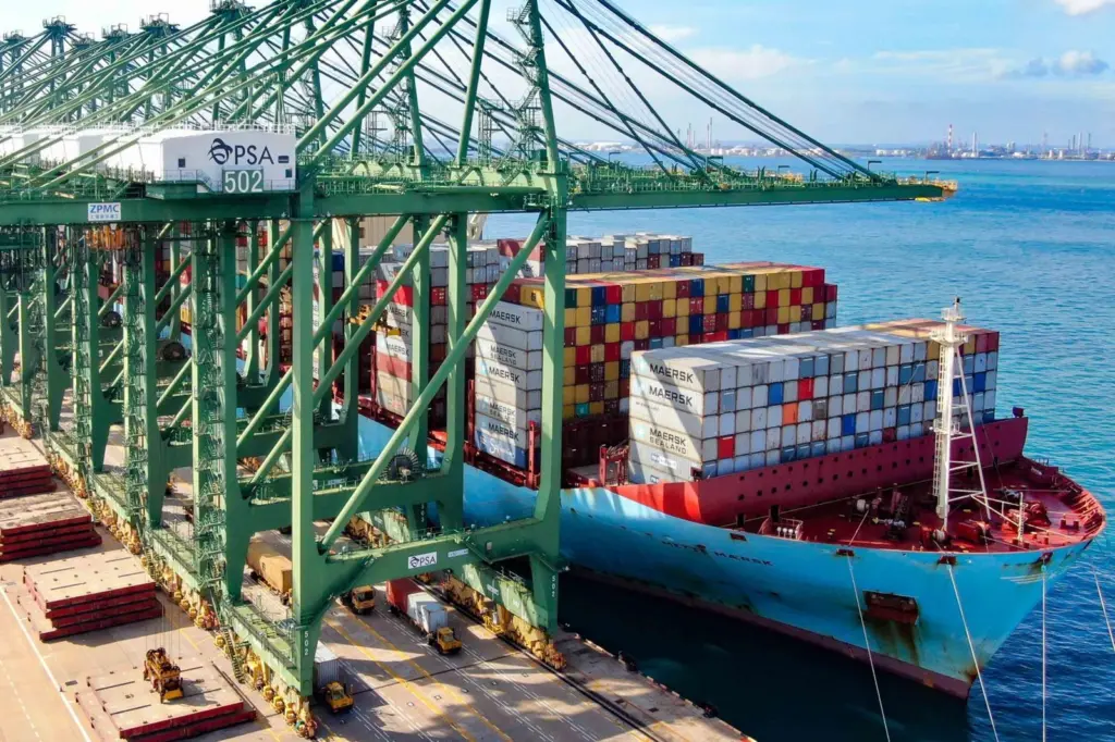 The image shows a view of the quayside at PSA Singapore