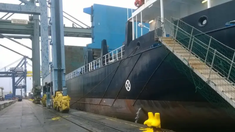 The image shows a ship berthed at the docks during a stopover