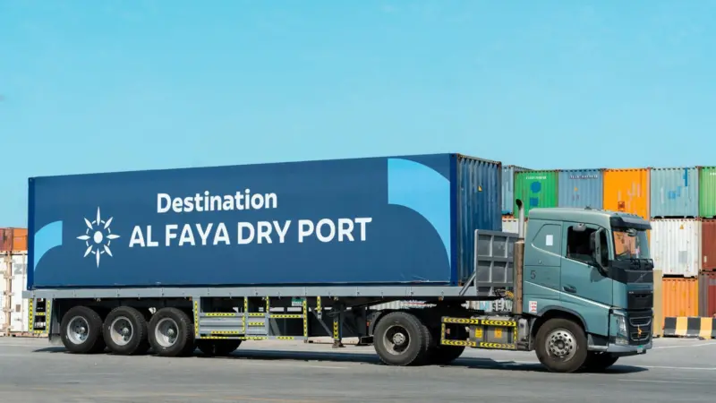 The image shows a truck serving the Al Faya Dry Port Facility